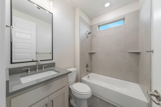 full bathroom with toilet, tiled shower / bath combo, and vanity