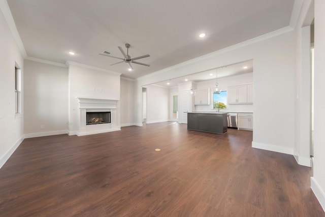 unfurnished living room with ceiling fan, crown molding, dark hardwood / wood-style flooring, and sink