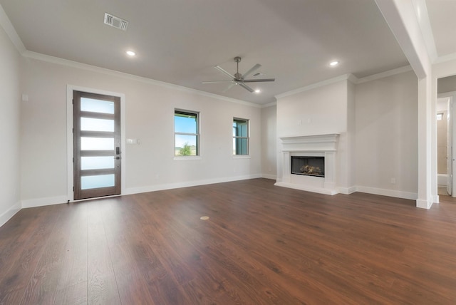 unfurnished living room with dark wood-type flooring, ceiling fan, and crown molding