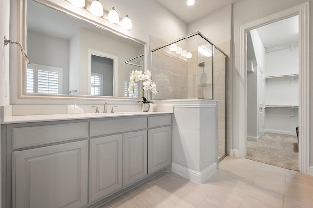 bathroom with vanity and a shower with door