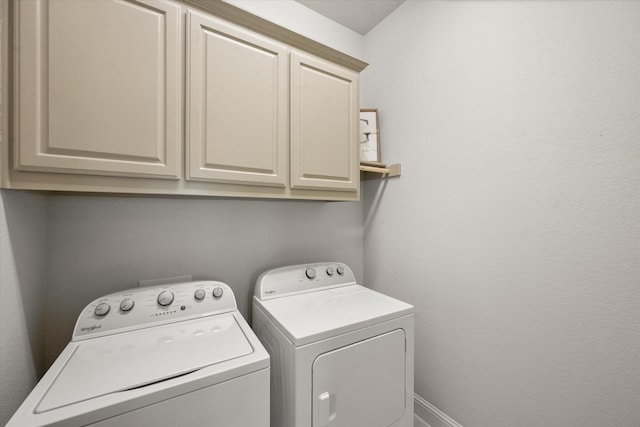 laundry area featuring cabinets and washing machine and clothes dryer