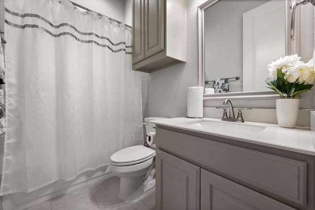 bathroom with toilet, tile patterned floors, and vanity