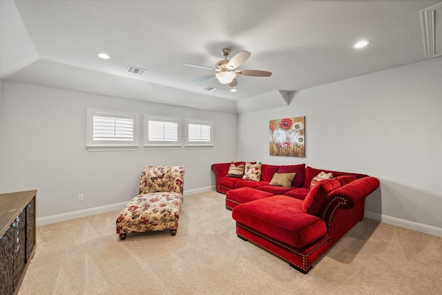 carpeted living room with ceiling fan