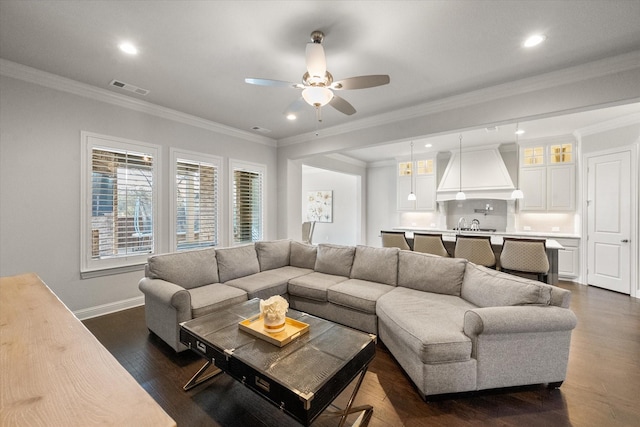 living room featuring ceiling fan, dark hardwood / wood-style flooring, and crown molding