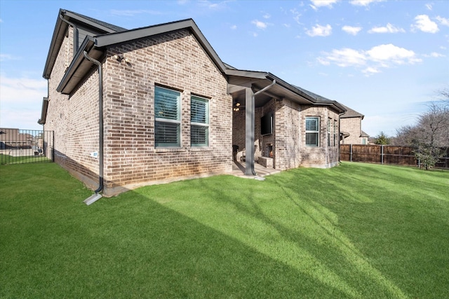 rear view of house featuring a lawn