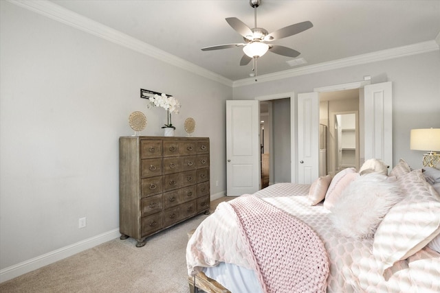 carpeted bedroom with ceiling fan, a closet, a spacious closet, and crown molding