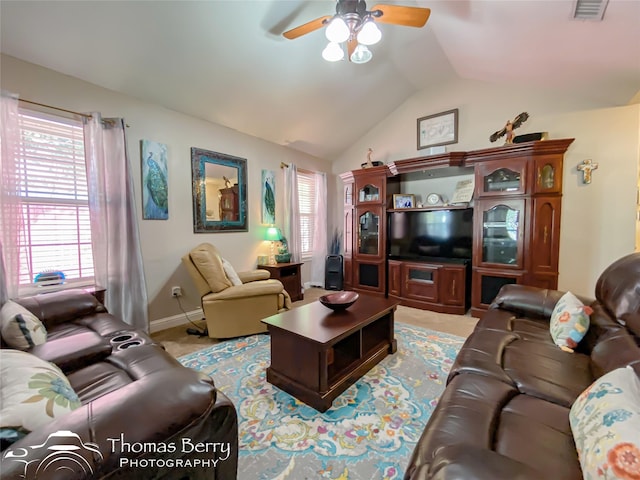 living room featuring ceiling fan and lofted ceiling