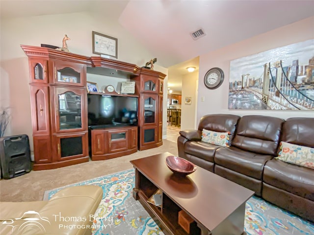 carpeted living room featuring vaulted ceiling