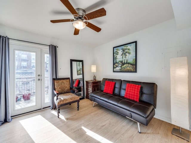 living room with ceiling fan and light hardwood / wood-style floors