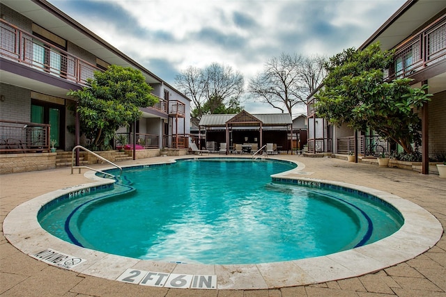 view of swimming pool featuring a patio area