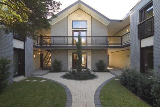 back of house with a balcony and a yard