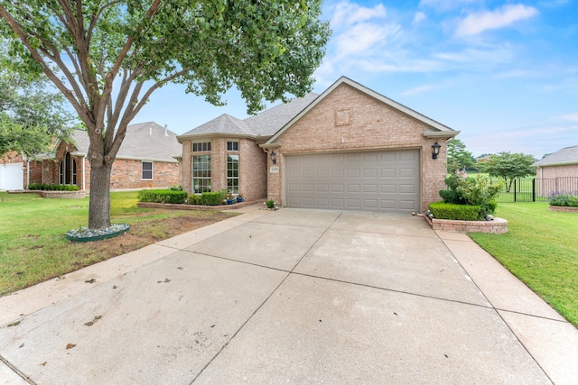 view of front of property with a garage and a front lawn