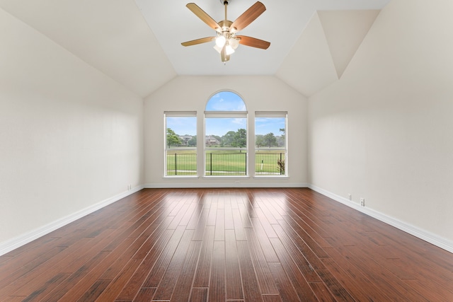 empty room featuring ceiling fan, vaulted ceiling, and dark hardwood / wood-style floors