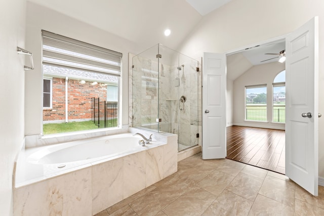 bathroom with ceiling fan, vaulted ceiling, and independent shower and bath