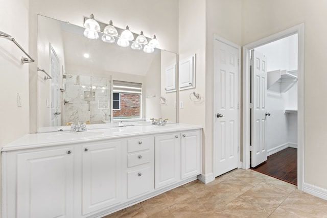 bathroom with walk in shower and vanity