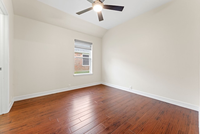 empty room with ceiling fan, hardwood / wood-style floors, and vaulted ceiling