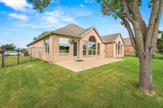 back of property featuring a patio area and a lawn