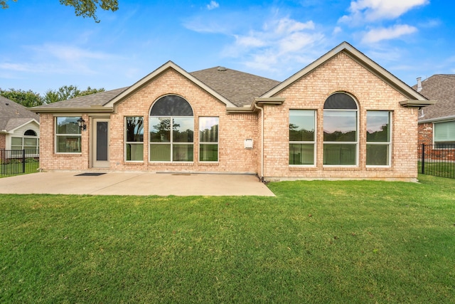 rear view of house with a patio and a yard