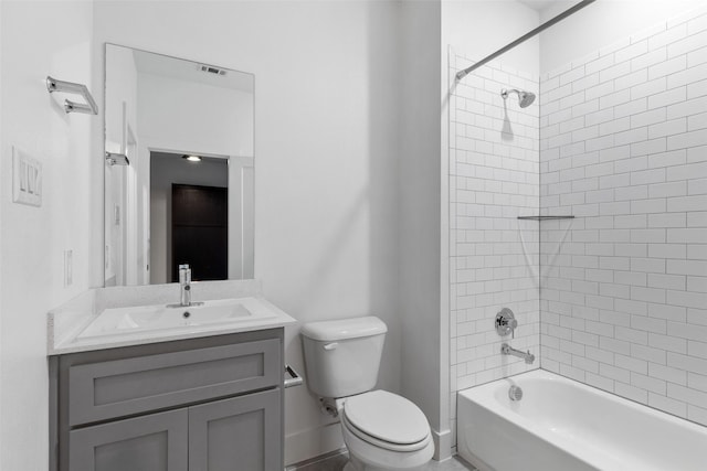 full bathroom featuring toilet, tiled shower / bath, and vanity