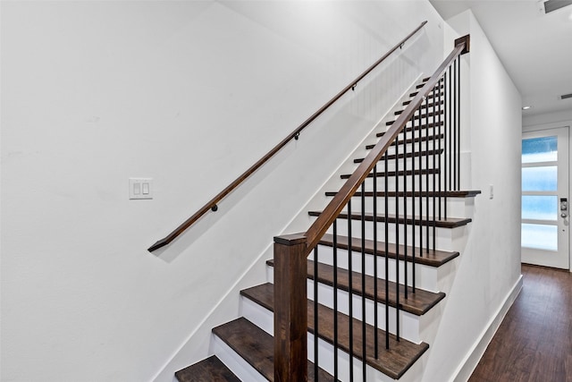 staircase featuring wood-type flooring