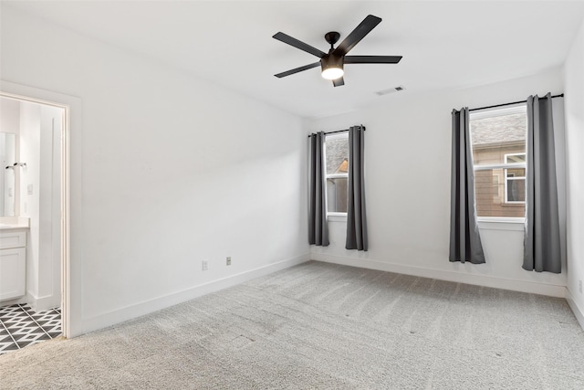 carpeted spare room with ceiling fan