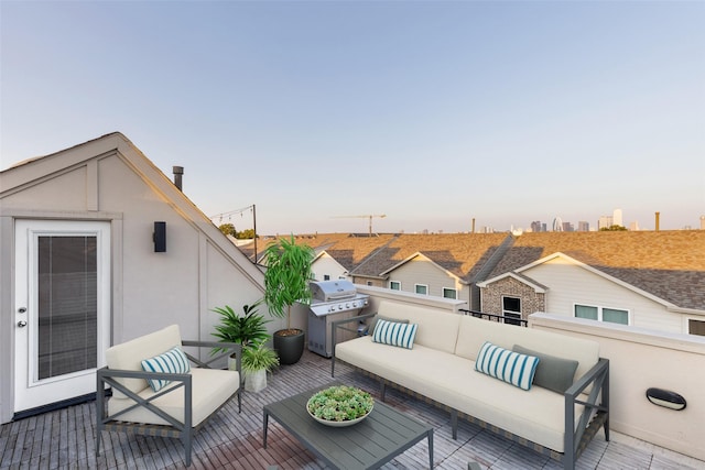 deck at dusk featuring a grill and an outdoor living space