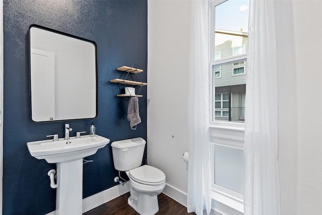 bathroom featuring hardwood / wood-style floors and toilet