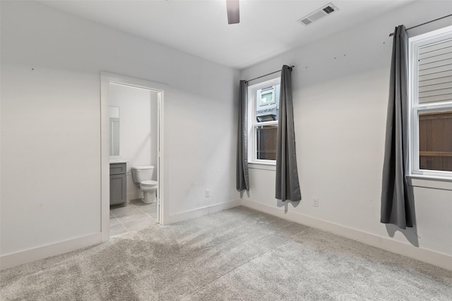 carpeted spare room with ceiling fan