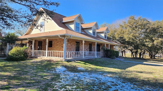 view of side of home featuring a porch and a lawn