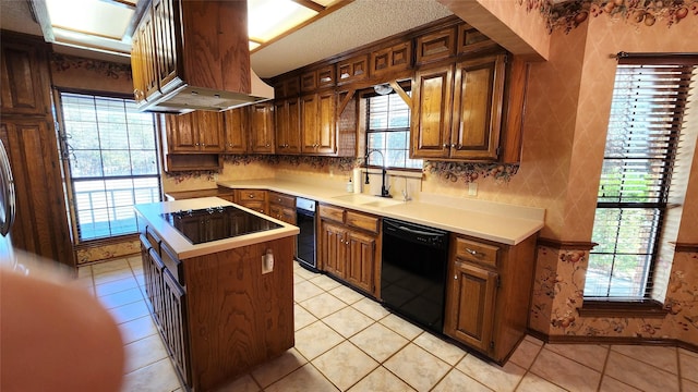 kitchen with sink, a center island, light tile patterned floors, island range hood, and black appliances