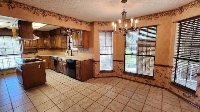 kitchen with black appliances, decorative light fixtures, a textured ceiling, and a kitchen island