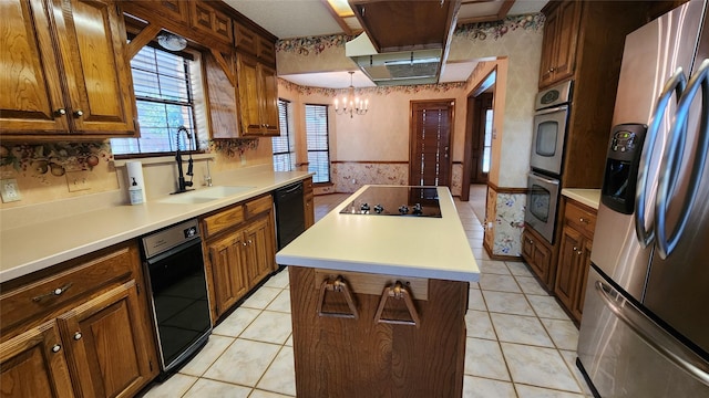 kitchen featuring sink, a center island, light tile patterned flooring, a chandelier, and black appliances