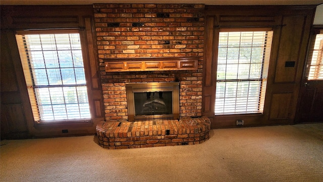 unfurnished living room with a fireplace and carpet floors