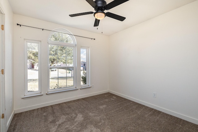 carpeted spare room with ceiling fan