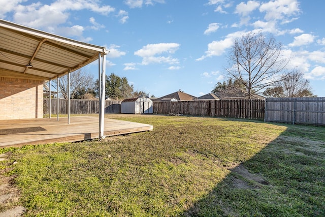 view of yard with a deck and a shed