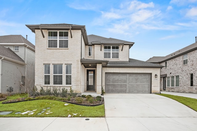 view of front of home with a garage and a front yard