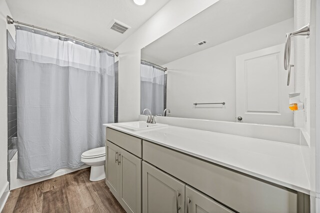 carpeted bedroom with ceiling fan and a tray ceiling