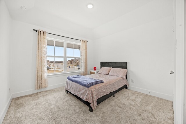 carpeted bedroom featuring ceiling fan and vaulted ceiling