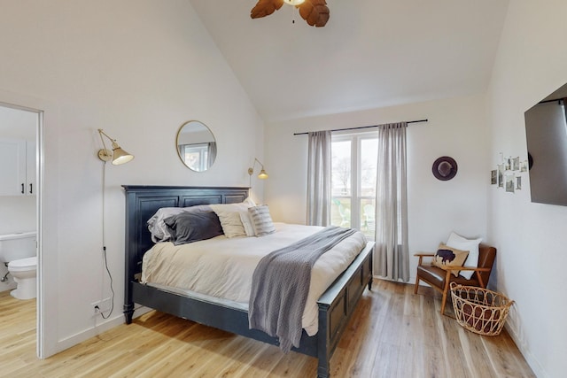 bedroom featuring high vaulted ceiling, light wood-type flooring, ceiling fan, and connected bathroom