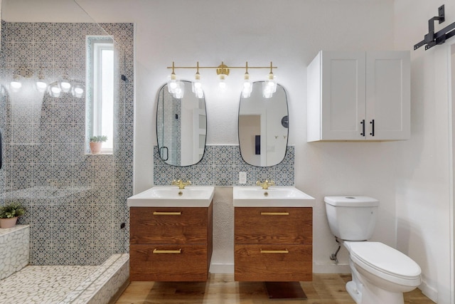 bathroom with tiled shower, backsplash, and a healthy amount of sunlight