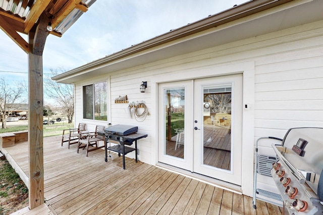 deck with french doors and area for grilling