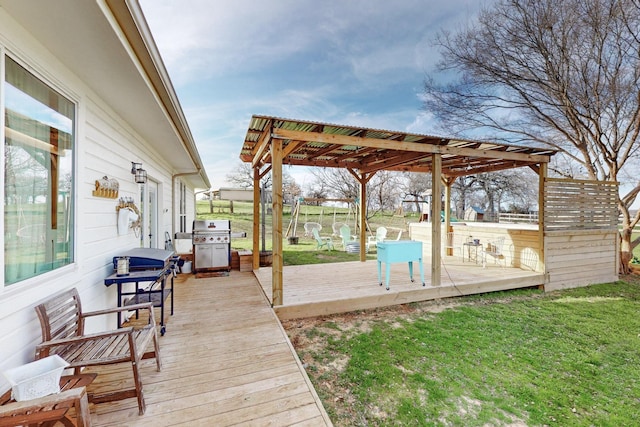 deck with a lawn, area for grilling, and a pergola