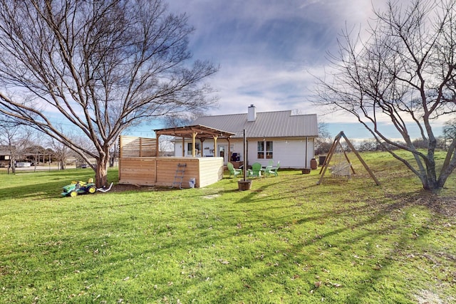 back of house featuring a yard and a pergola