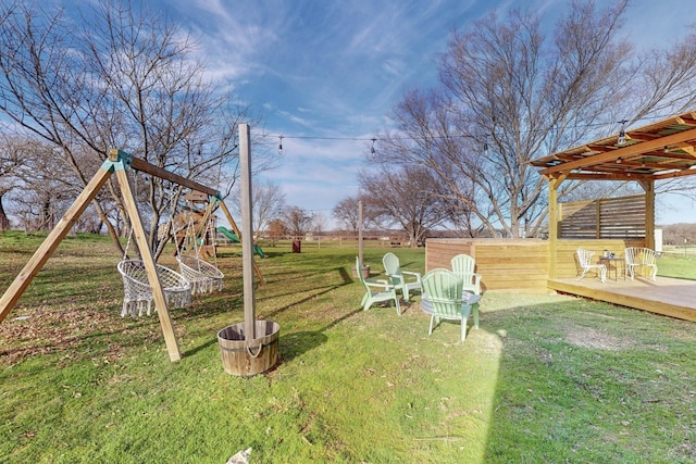 view of yard with a deck and a playground