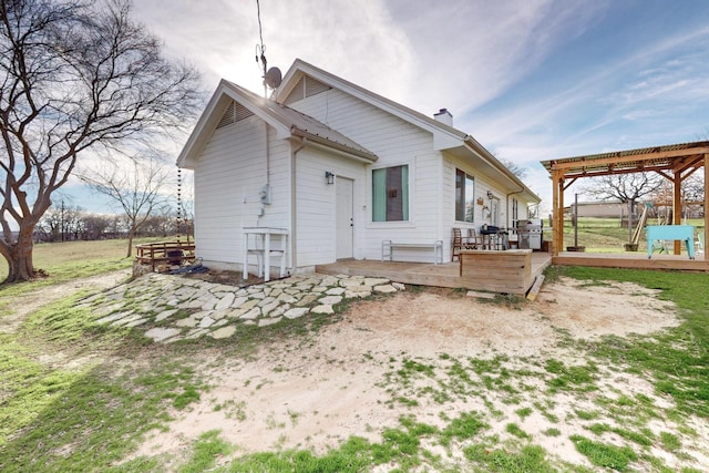 back of property with a wooden deck