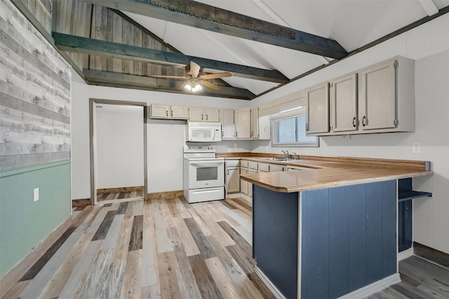 kitchen with white appliances, lofted ceiling with beams, kitchen peninsula, ceiling fan, and sink