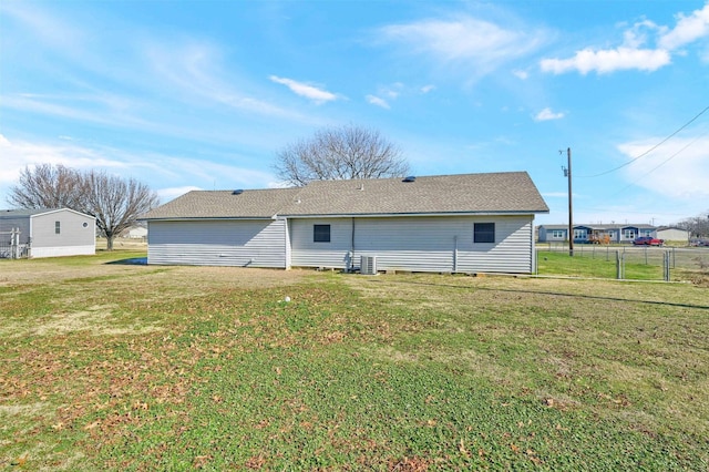 rear view of property featuring a lawn