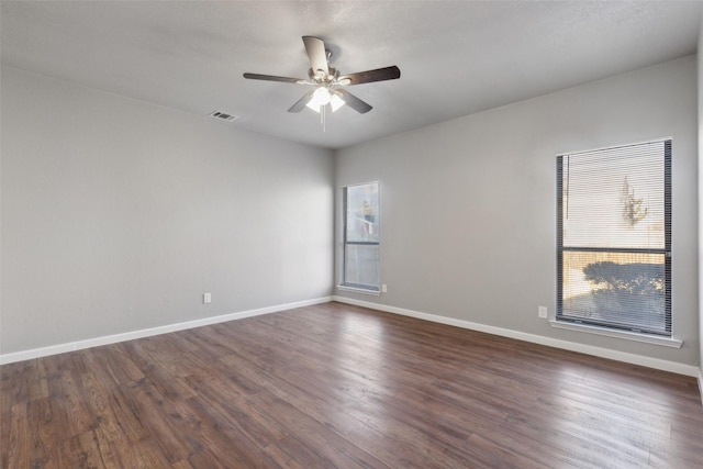 spare room with ceiling fan and dark wood-type flooring