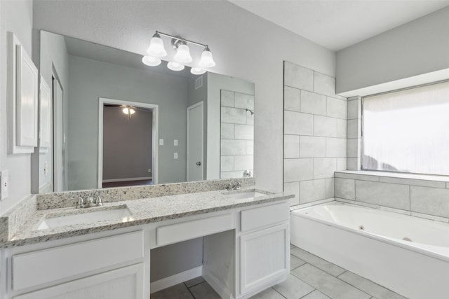 bathroom featuring tile patterned flooring, a bath, and vanity