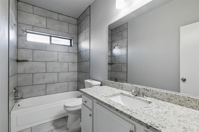 full bathroom with toilet, vanity, and tiled shower / bath